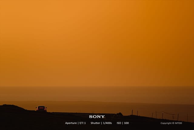 Sunset over Qinghai Lake with golden light and dramatic landscape